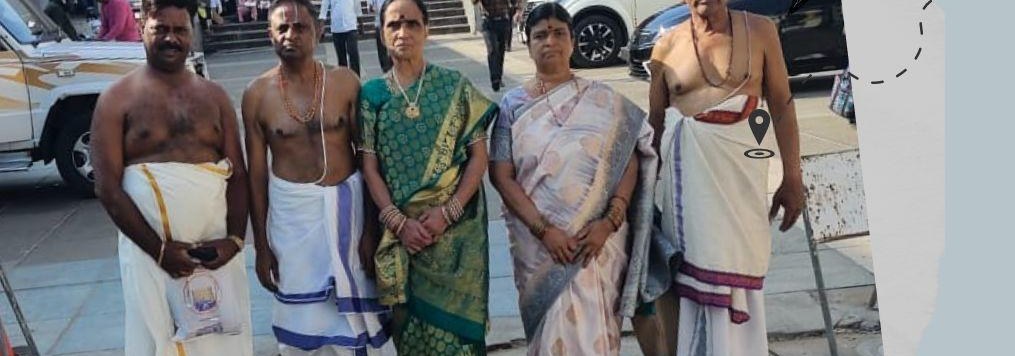 A family in traditional dress outside a temple during their Kerala temple tour